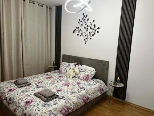 a bedroom with a bed with a teddy bear on it at Aspen Pirin View in Razlog