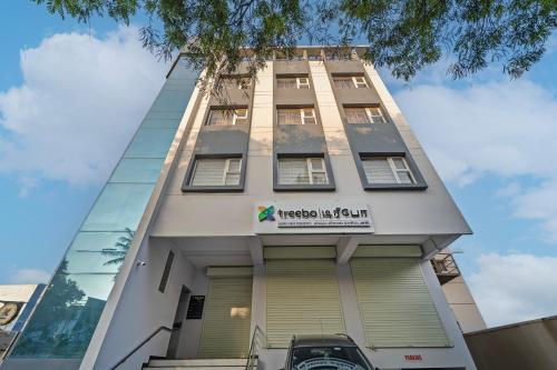 a tall building with a sign on it at Treebo Viswa Vikas Residency in Coimbatore