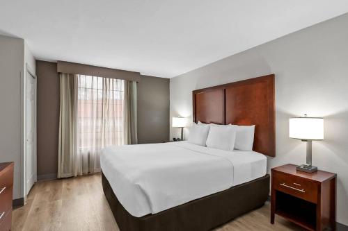 a large white bed in a hotel room at Comfort Suites Near Potomac Mills in Woodbridge