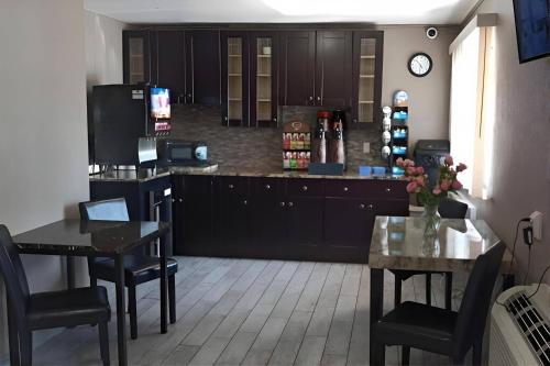 a kitchen with two tables and a counter top at Econo Lodge Inn & Suites Yuma in Yuma