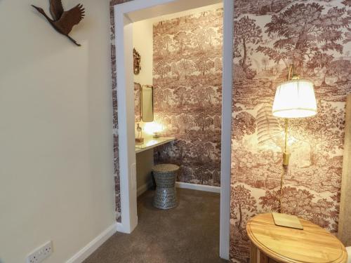 a hallway with a room with a table and a bathroom at South Segganwell - Culzean Castle in Maybole