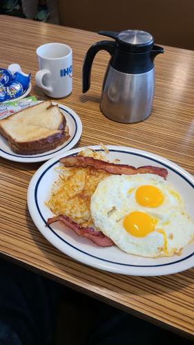 a breakfast plate with eggs and toast on a table at Hotel suites Las Abuelas in Copán Ruinas