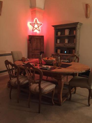 a dining room with a wooden table and chairs at Antica Dimora Giardini Segreti in Giuggianello