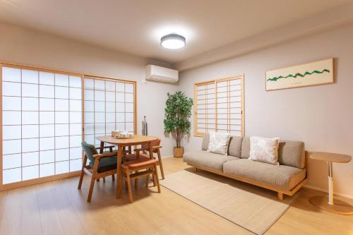 a living room with a couch and a table at フォレステージ嵐山 in Kyoto