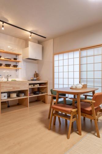 a kitchen with a table and two chairs and a table at フォレステージ嵐山 in Kyoto