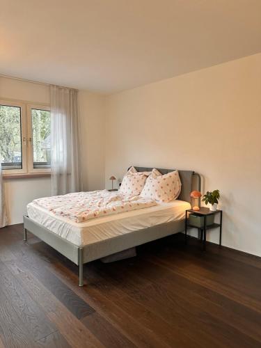 a bedroom with a large bed with pink pillows at HAUS AM SEE - Natur Pur in Friedenweiler