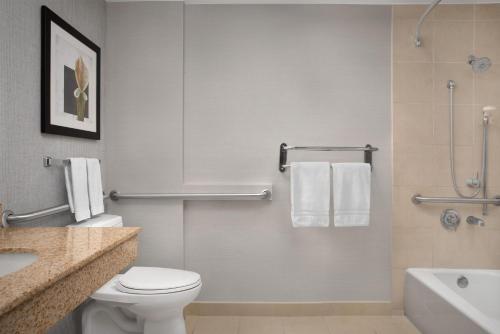 a bathroom with a toilet and a sink and a shower at Hilton Garden Inn Tallahassee Central in Tallahassee