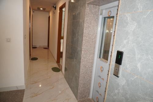 a hallway with a stone wall and a mirror at Hotel JR Palace- Near Toran Dwar and free Parking in Khātu