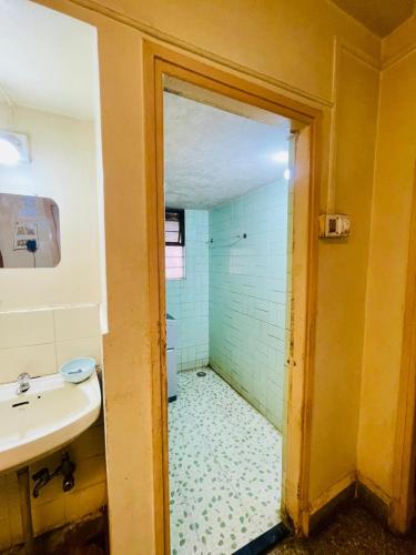 a bathroom with a sink and a shower at Flora 2bhk Kothrud MIT WPU in Pune