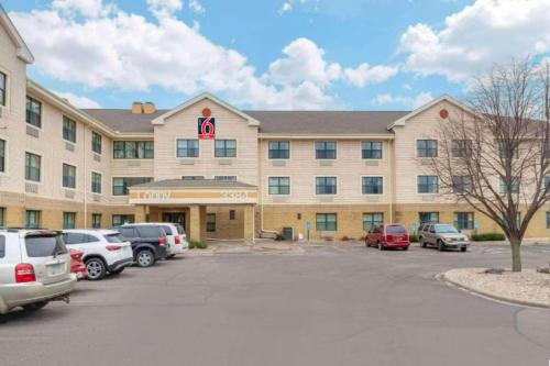 a hotel with cars parked in a parking lot at Studio 6 Extended Stay Minneapolis Airport Eagan MN in Eagan