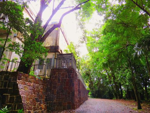 a brick path leading to a building with a balcony at Dos Aguas in Rio Grande