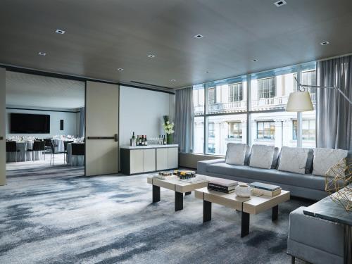 a living room with a couch and a table at The Langham, New York, Fifth Avenue in New York