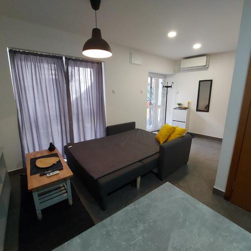 a living room with a couch and a table at Hidden place in pure center in Novi Sad