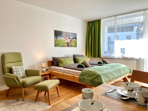 a bedroom with a bed and a table and chairs at Hirschzauber A9 Montana Haus in Oberstdorf