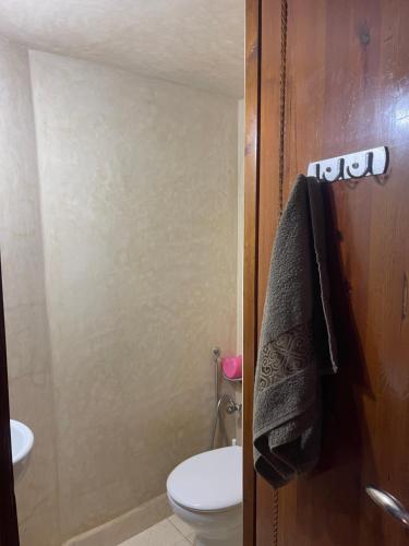 a bathroom with a toilet and a sink and a shower at Appartement Marrakech in Marrakesh