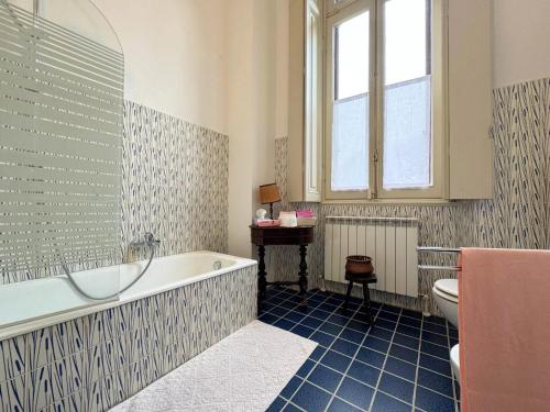 a bathroom with a tub and a toilet and a sink at Villa Cervi in Ronco Todeschino