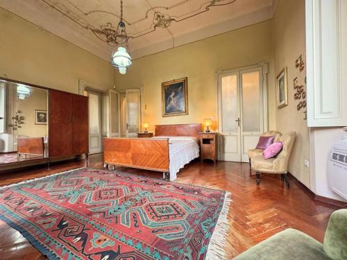 a bedroom with a bed and a table and a rug at Villa Cervi in Ronco Todeschino