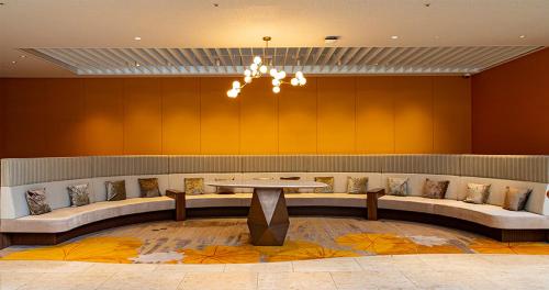 a waiting room with a table and benches at Phoenix Seagaia Ocean Tower in Miyazaki