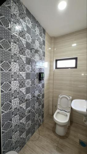 a bathroom with a toilet and a sink at LE dEON HOTEL Former Pine Hotel in Batu Gajah