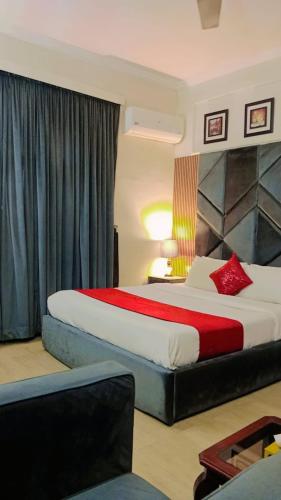 a hotel room with two beds and a couch at Royal Executive in Islamabad