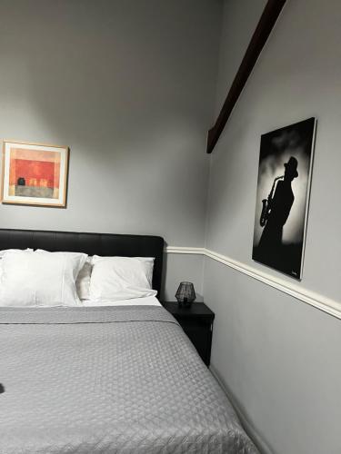 a bedroom with a bed and a picture of a man on a motorcycle at Nid Parisien in Cachan