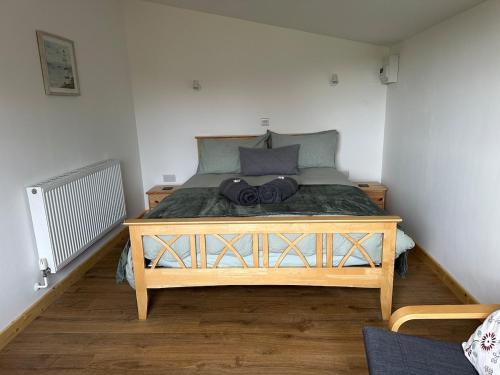 a bedroom with a large wooden bed in a room at The Apple Press in Williton