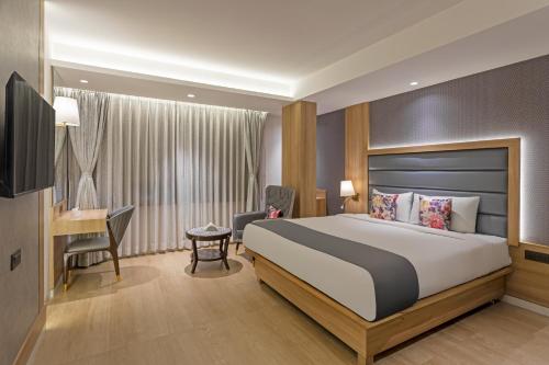 a hotel room with a bed and a desk at Hill Berry - A SoVo Hotel in Lonavala