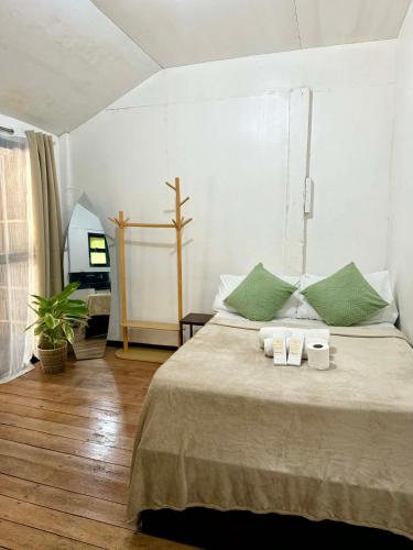 a bedroom with a bed with two towels on it at Namastay Siargao in General Luna