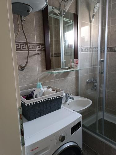 a bathroom with a sink and a shower at Apartman Centar in Modriča