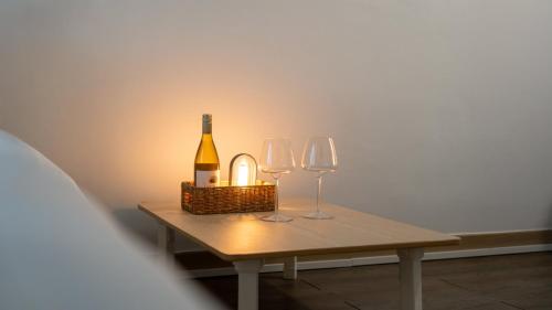 a table with a bottle of wine and two glasses at Goseong Jajackdo Aroma Pension in Goseong