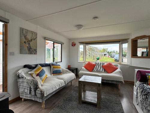 a living room with a couch and a table at Stable Lodge in Williton