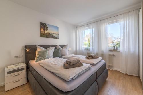 a bedroom with a large bed with towels on it at Fewo Resaleen in Öhningen