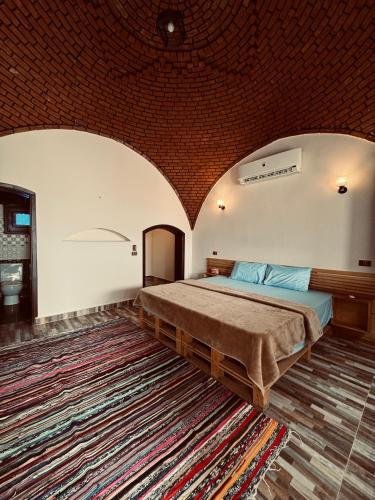 a bedroom with a bed and a large rug at Dana beach camp in Nuweiba