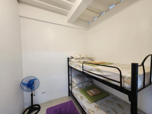 a bedroom with two bunk beds in a room at Caishen Apartelle 201 in Sabutan