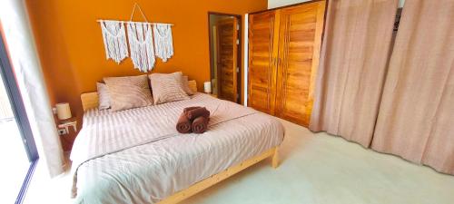 a dog sitting on a bed in a bedroom at Samma Villas - Agate Villa - 1 BDR & private pool in Ko Phangan