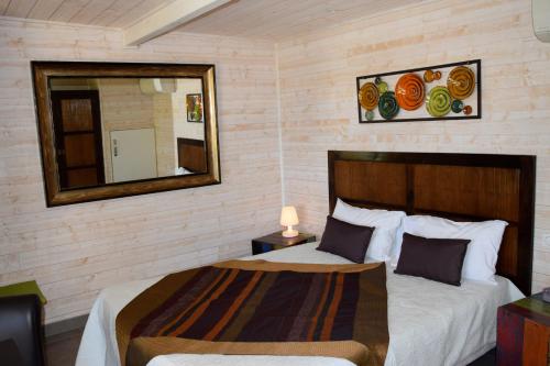 a bedroom with two beds and a mirror and a mirror at Timazen Lodges Agen Sud in Aubiac