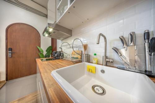 a kitchen with a large white sink in a kitchen at Swing By in Bangkok
