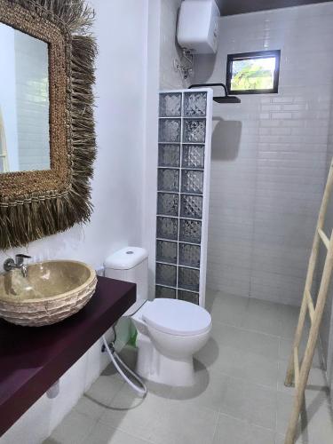 a bathroom with a toilet and a sink at Stars Villa in Ngingas