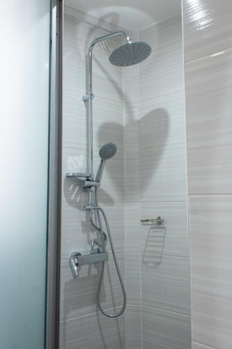 a shower with a shower head in a bathroom at Unique Bed and Breakfast- A Home Away From Home in Harare