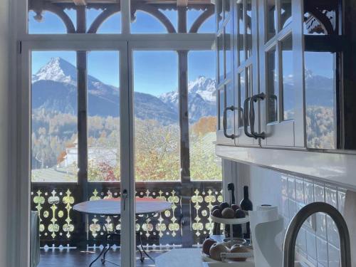 a room with a large window with a view of mountains at Rottenhöfer Retreat Villa in Berchtesgaden