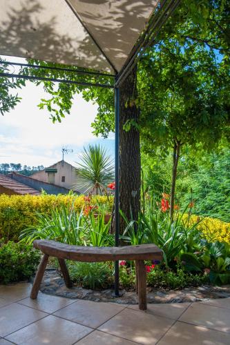 a wooden bench sitting in front of a garden at Moinhos do Pisão in Povoa Dao