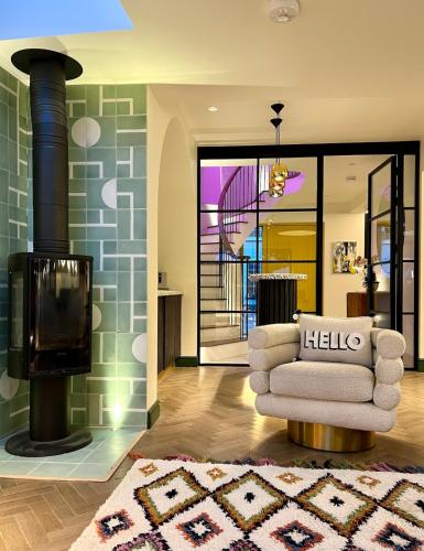 a living room with a couch and a fireplace at Chic Devon Designer Oasis with hot tub in Malborough