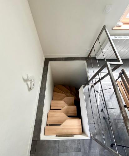 a staircase in a house with wooden floors at L'Escale à Villerville in Villerville