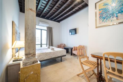 a bedroom with a bed and a table in a room at GAV Santa Pola in Ronda