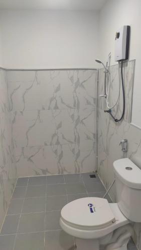 a bathroom with a toilet and a shower at Nana's Bar & Hotel in Nong Prue
