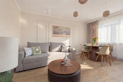 a living room with a couch and a table at Marina Apartament Old Town View in Kamień Pomorski