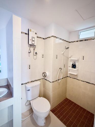 a bathroom with a toilet and a shower at Hi2 Cha-Am in Cha Am