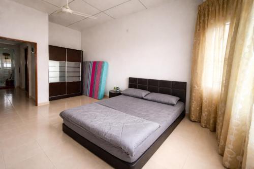 a bedroom with a large bed in a room at Rex Zone Homestay in Bedung