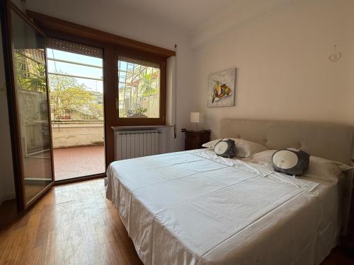 a bedroom with a bed and a large window at Gt holiday in Rome