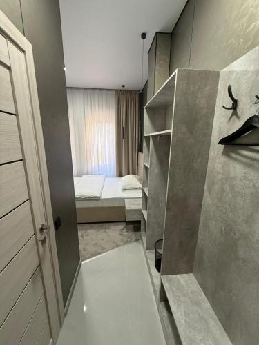 a small room with a bed and a small bedroom at Khan Boutique Hotel in Almaty